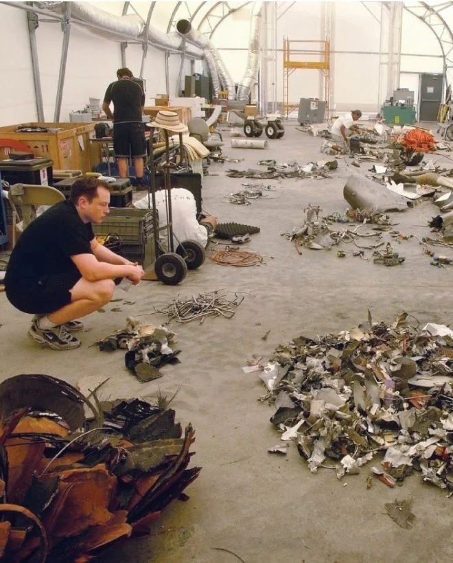 elon musk examining falcon 1 debris